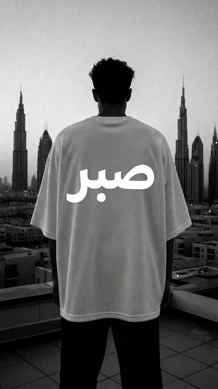 Figure on Dubai rooftop wearing SABR tee with Arabic back print
